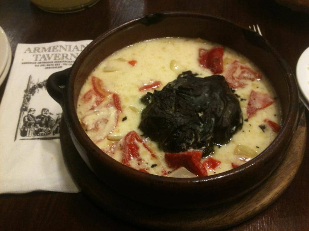 Minced meat in vine leaves and yogurt sauce