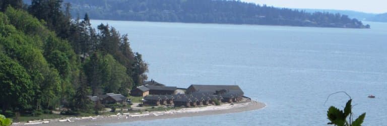 View from overlook on Cama Beach State Park Bluff Trail south towards cabins.