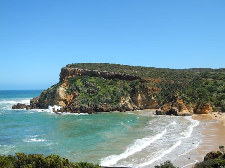 Beautiful sandy beach in between cliffs