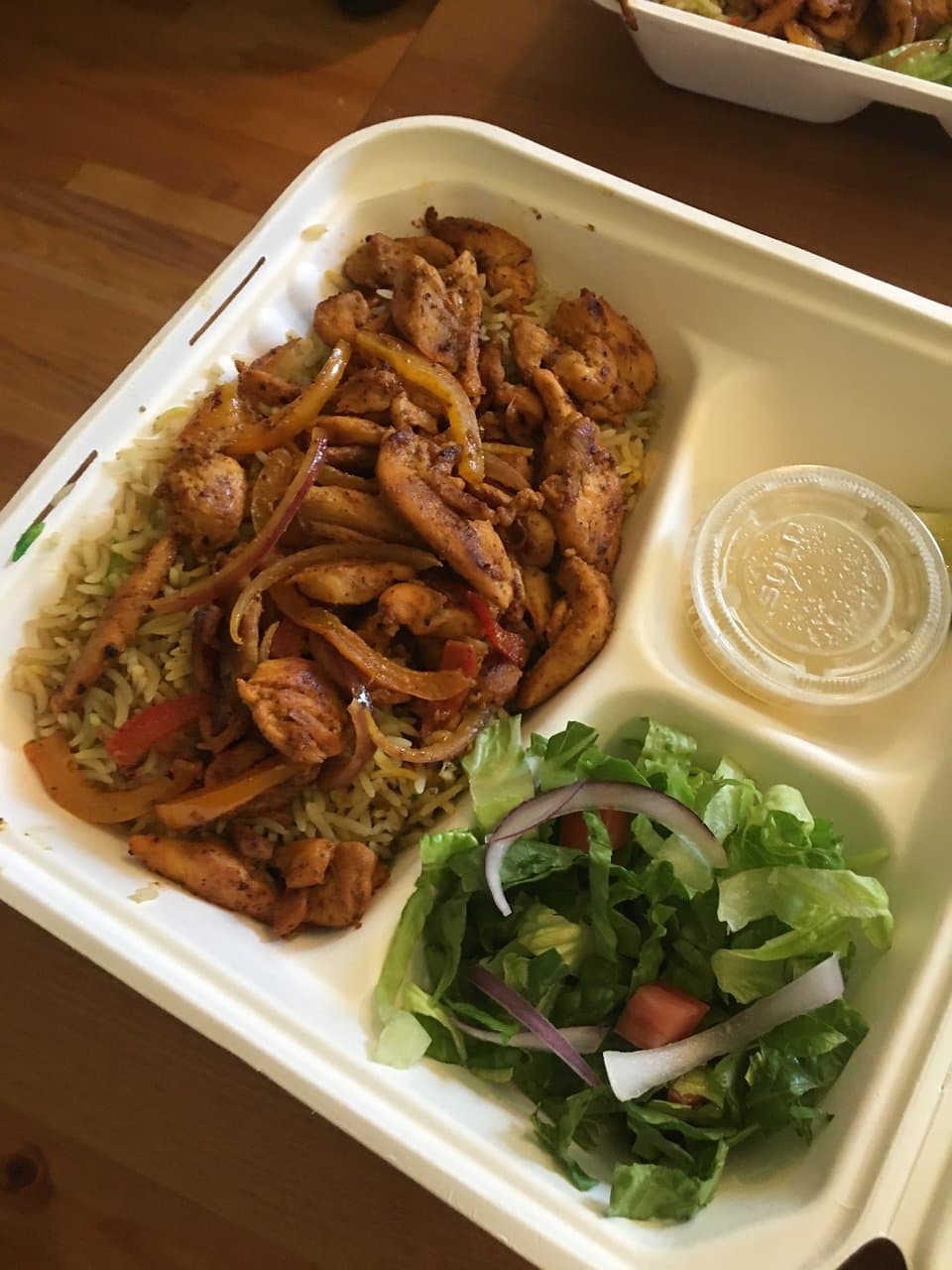 Somali Chicken and herbed rice with green salad; the lime is an accent to the rice (optional); the dressing for the salad is a lemon juice dressing.