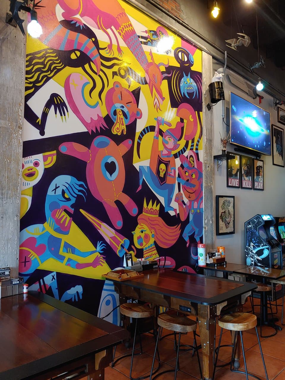 The mural oversees the board and video games.