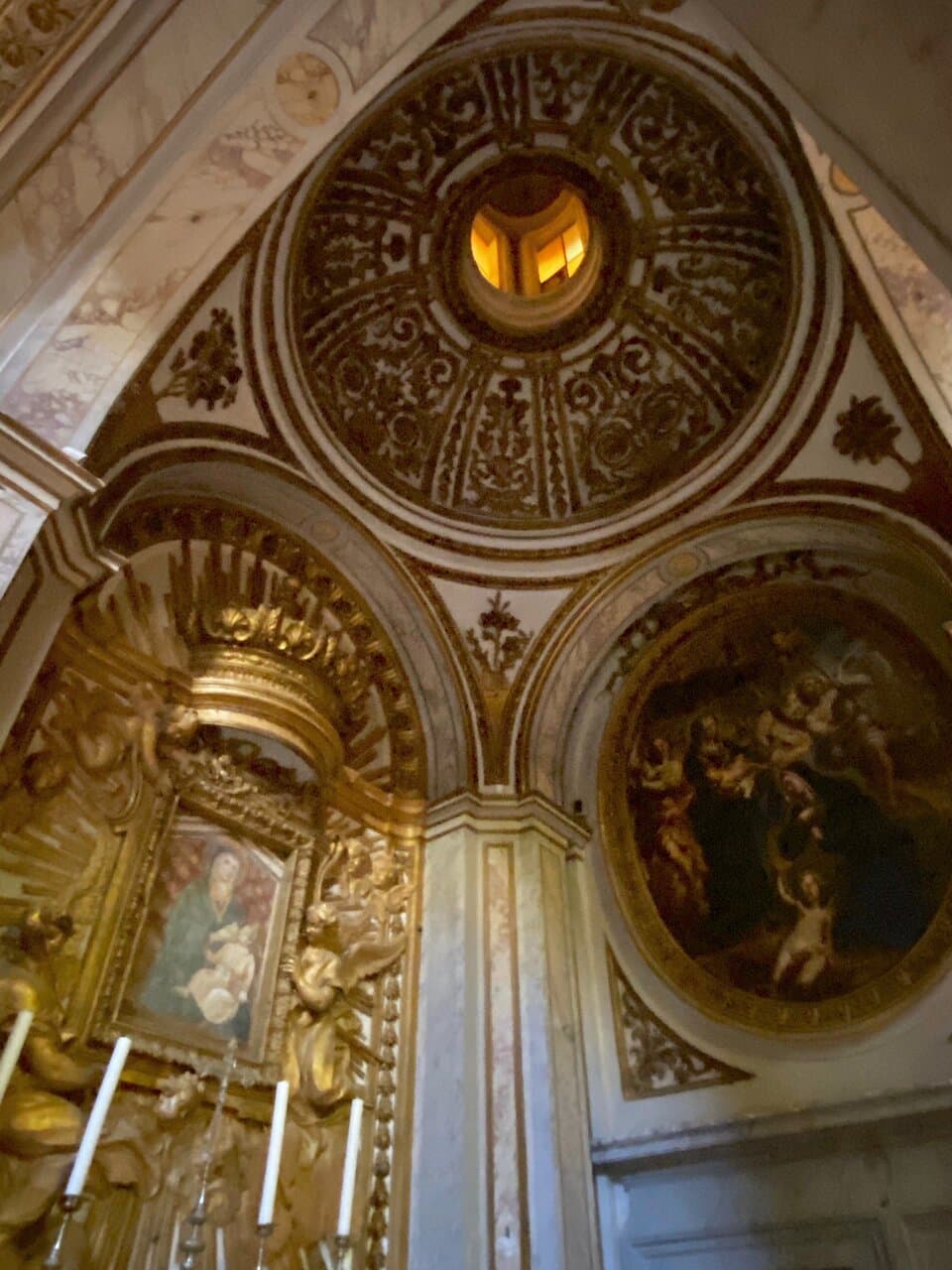 Sacristy. The sacristy is to the left of the sanctuary, and over its door is a painting “Virgin Mary delivering the Child to St. Clare of Assisi” by Biagio Puccini