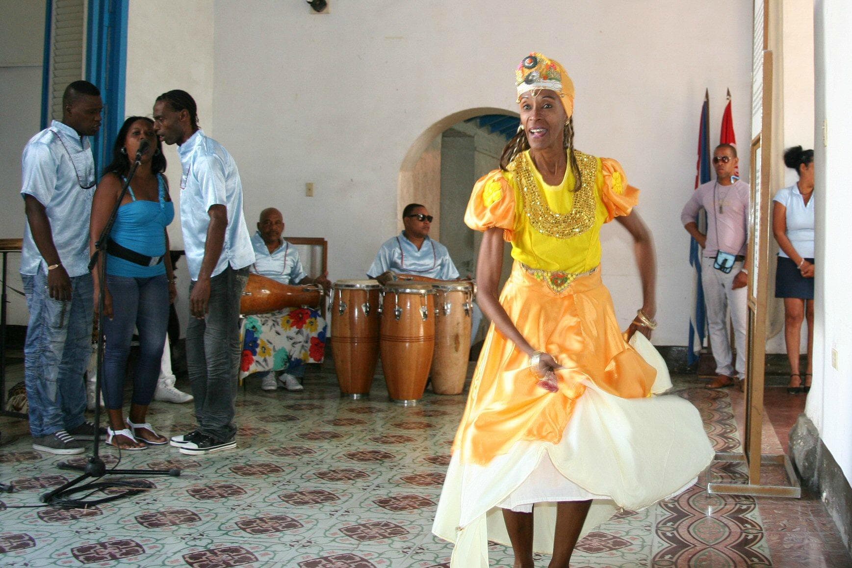 A dancer shows colors of the orisha Ochun
