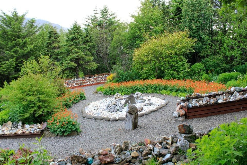 Beautiful garden with lots of flowers and stones.