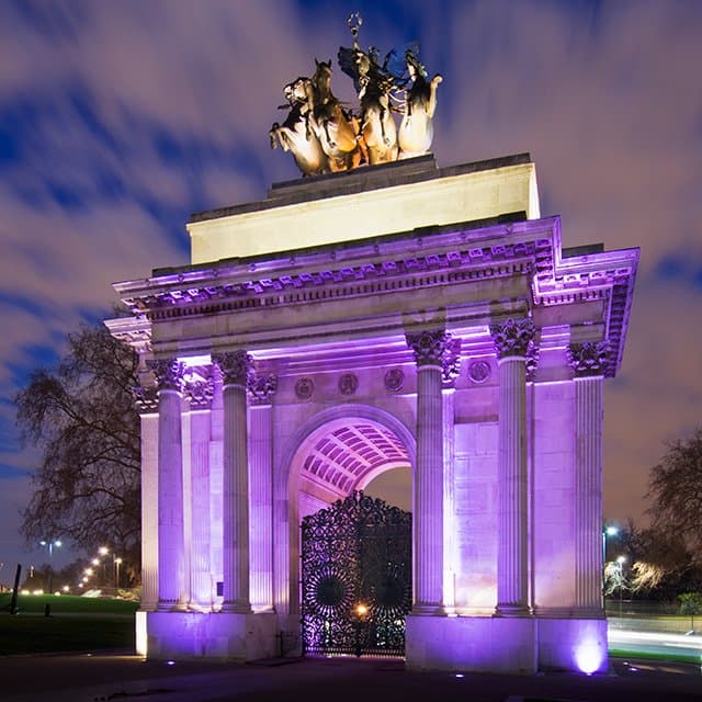 Wellington Arch illuminated at night. Visit during the Day for the views or hire the space at ni