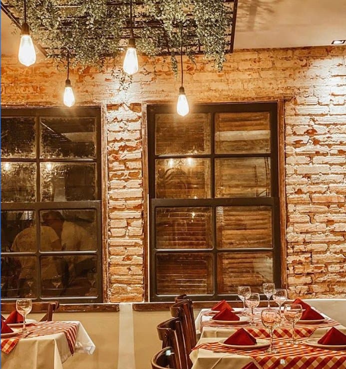 Foto do salão com mesas.