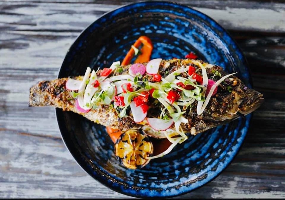 Our whole fish special changes depending on the catch! Garnished with crispy Brussels, chili oil, Romesco and charred lemon.