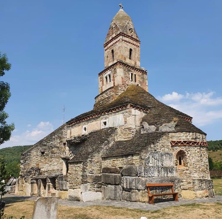The Densuș Church in the village of Densuș, Hunedoara County is the oldest stone church in Romania. It was built in its present form in the 13th century on the site of a 2nd-century Roman temple, with some materials from the Dacian Sarmizegetusa fortress. It has a stone tower above the naos.