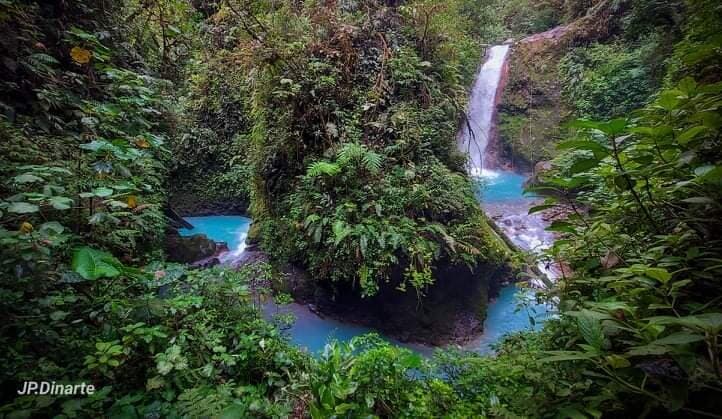 La Pintada waterfall - A non-swimmable blue waterfall but oh, what a design! You need to see it. Safely visitable with 90 steps, and afterward, it connects easily with the other blue waterfall La Turquesa. It is part of Blue Falls of Costa Rica, Bajos Del Toro, Sarchí, Costa Rica.
