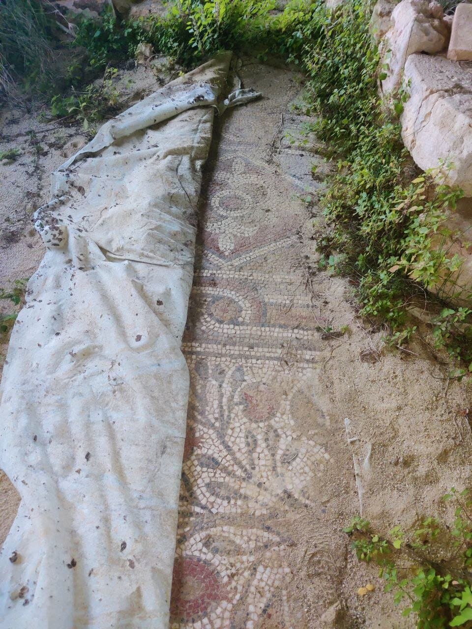 the hall floor mosaic covered to protect from sand