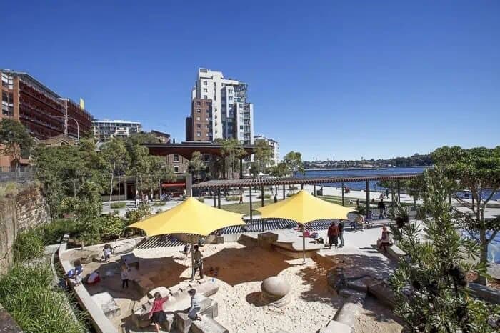 This 1.8 hectare park on Sydney Harbour has delightful walks along its wide avenues, plenty of grassy areas for picnics, plus the cafe and water play playground. There are BBQs and public toilets too. Swimming spot. Pyrmont water park. There are swings, a terrific rope climbing frame, great big sandpit under shade. The kids will love the spicas and slides as well. The accessible spinning roundabout is terrific too.