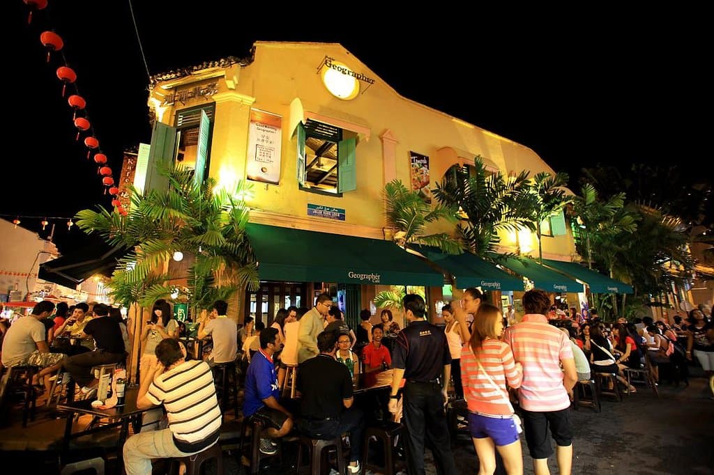 The iconic Geographér Café in the midst of a bustling crowd on Jonker Street, Melaka, Malaysia