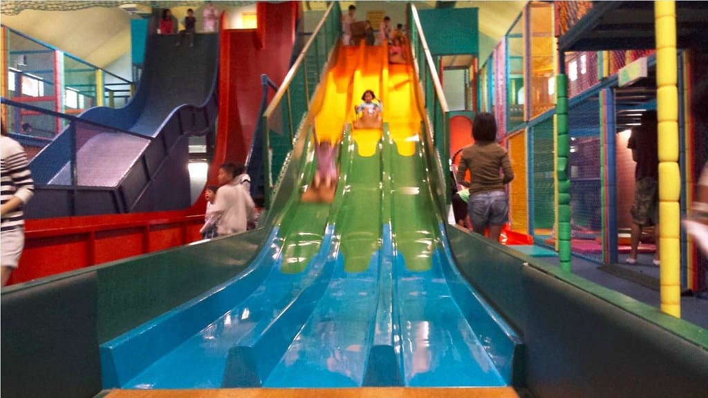 Kids on slide inside the Adventure Zone
