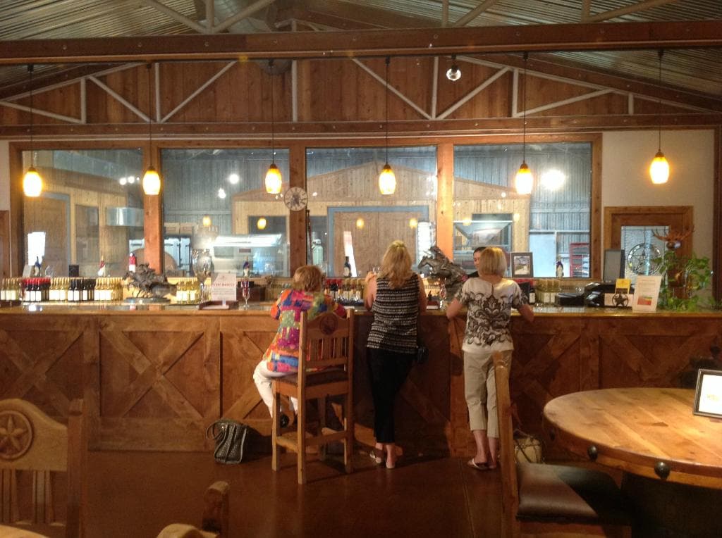 Tasting room counter with a very busy Emily manning the bar