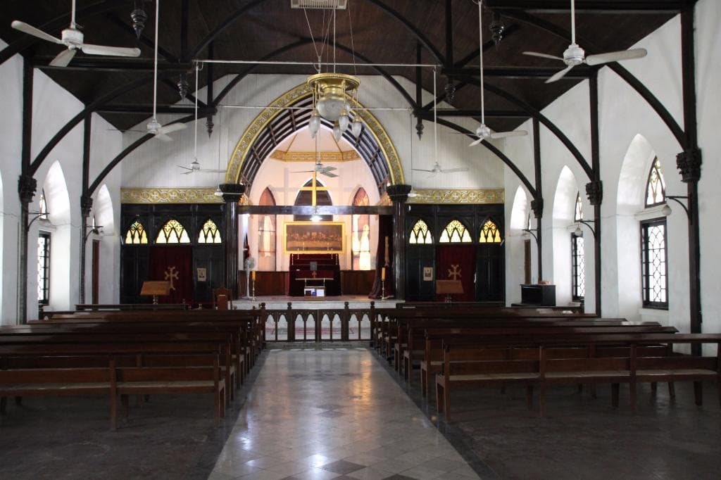 Interior showing altar, painting of the last supper and windows