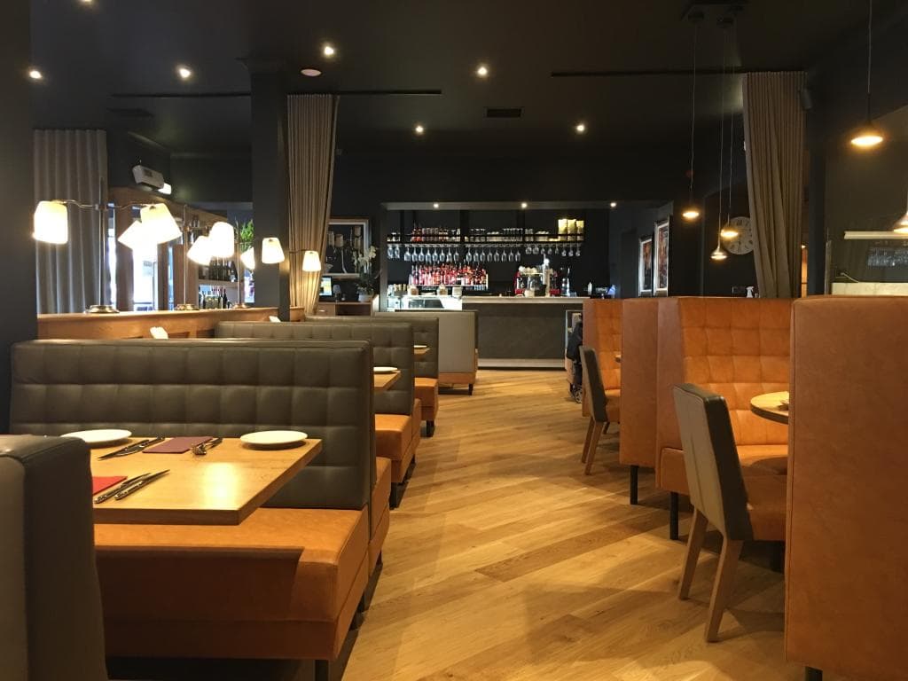 The bright interior looking from the far end of the restuarant toward the bar & entrance