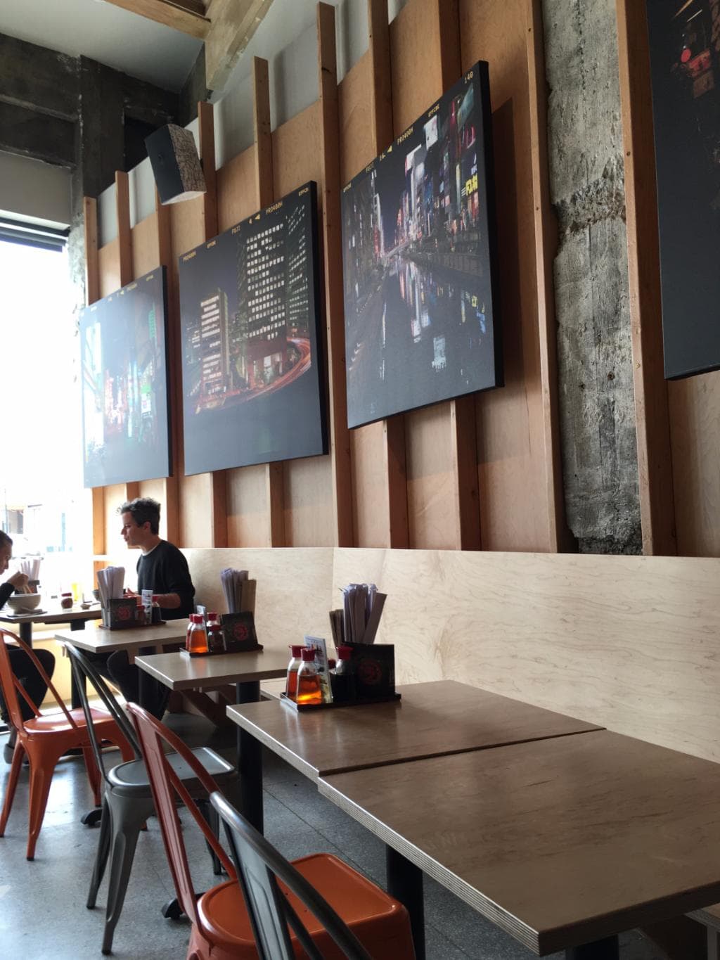 Seating banquette with open stud framing and plywood decor.