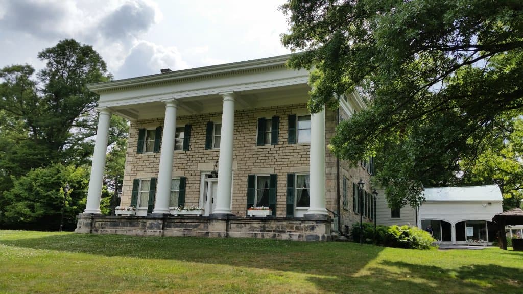 The front of the mansion with the old carriage house in the background.