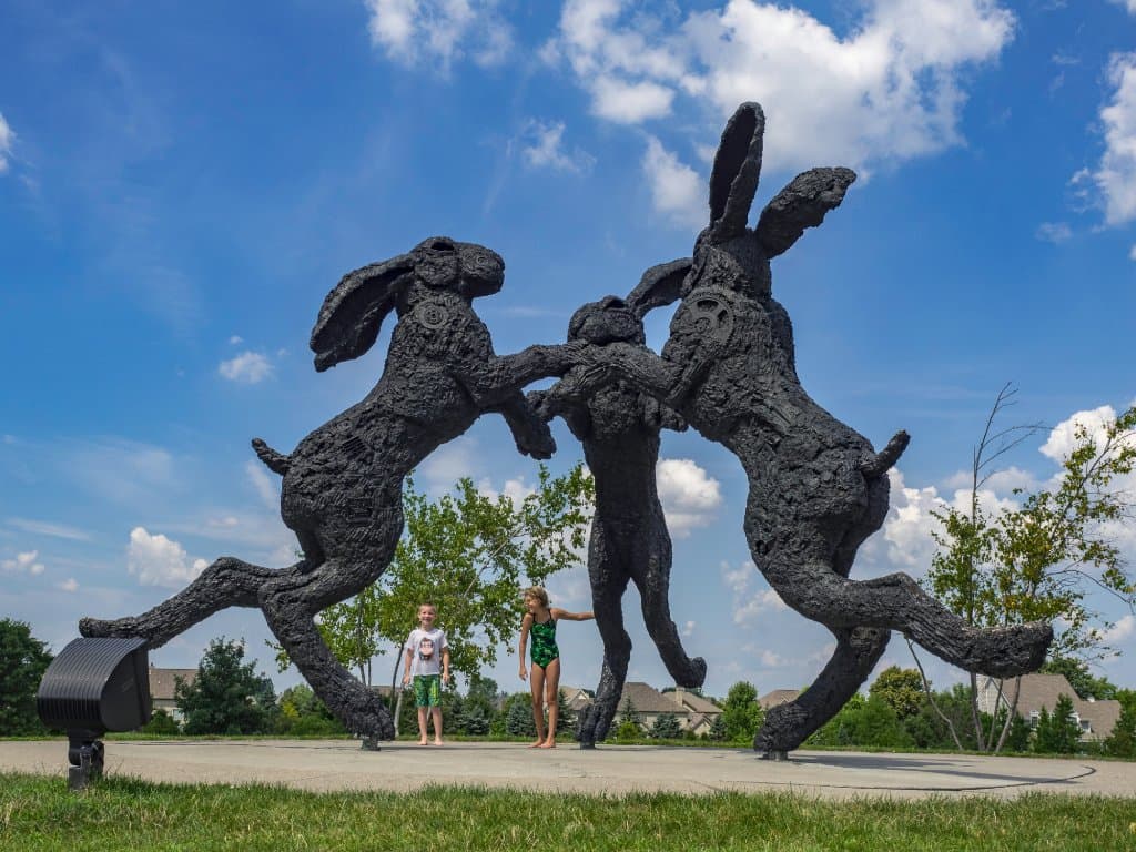 The rabbits are twenty-two feet high. Kids routinely sit on their protruding legs