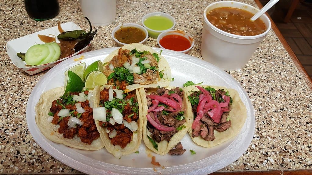 Carnitas, carne asada and al pastor tacos. The dark salsa is the one to go for