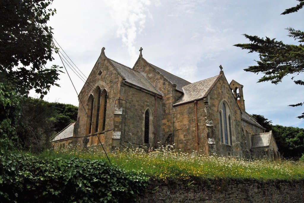 The church sets on the hillside beyond the canal