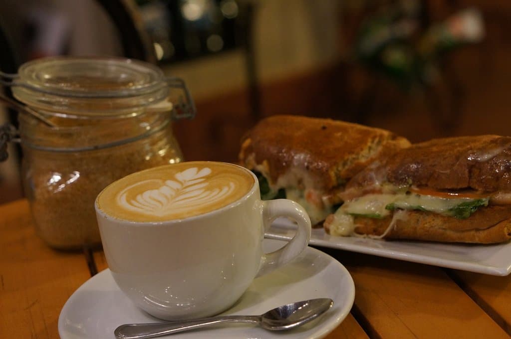 Coffee latte and turkey panini prepared with local fresh products from the farm
