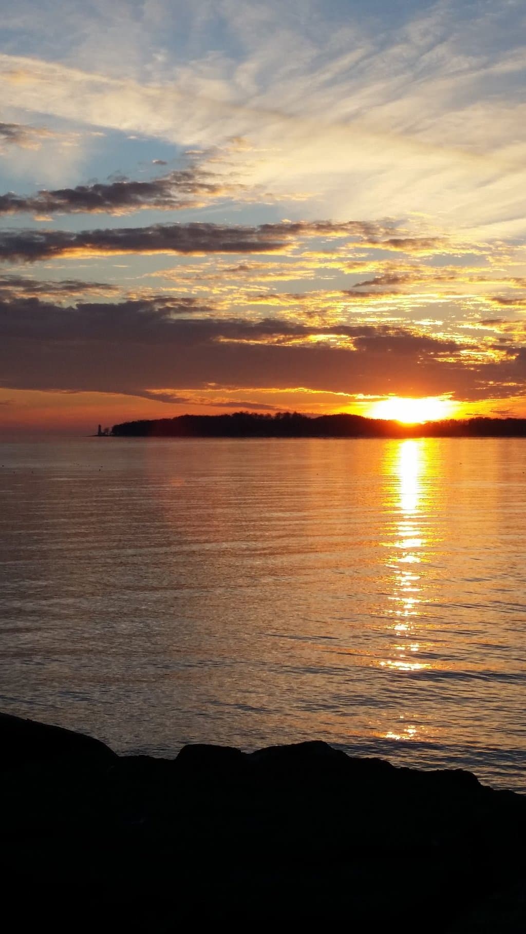 Winter sunset from the boat launch in Crystal Beach. Point Abino lighthouse is there on the left