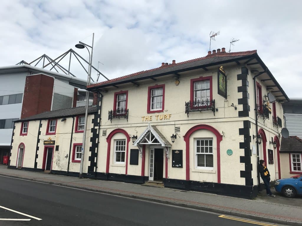 The Turf pub with Wrexhams Racecourse Ground in the background