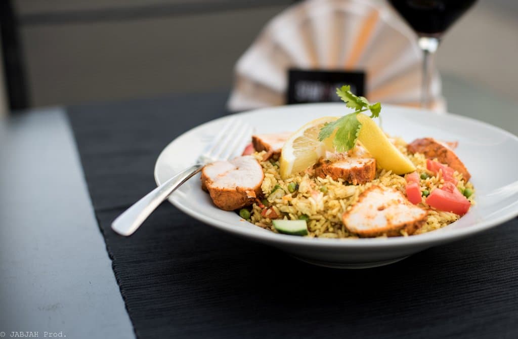 The cicken tikka biryani : basmati rice cooked in a thick gravy and flavored with spices & chick