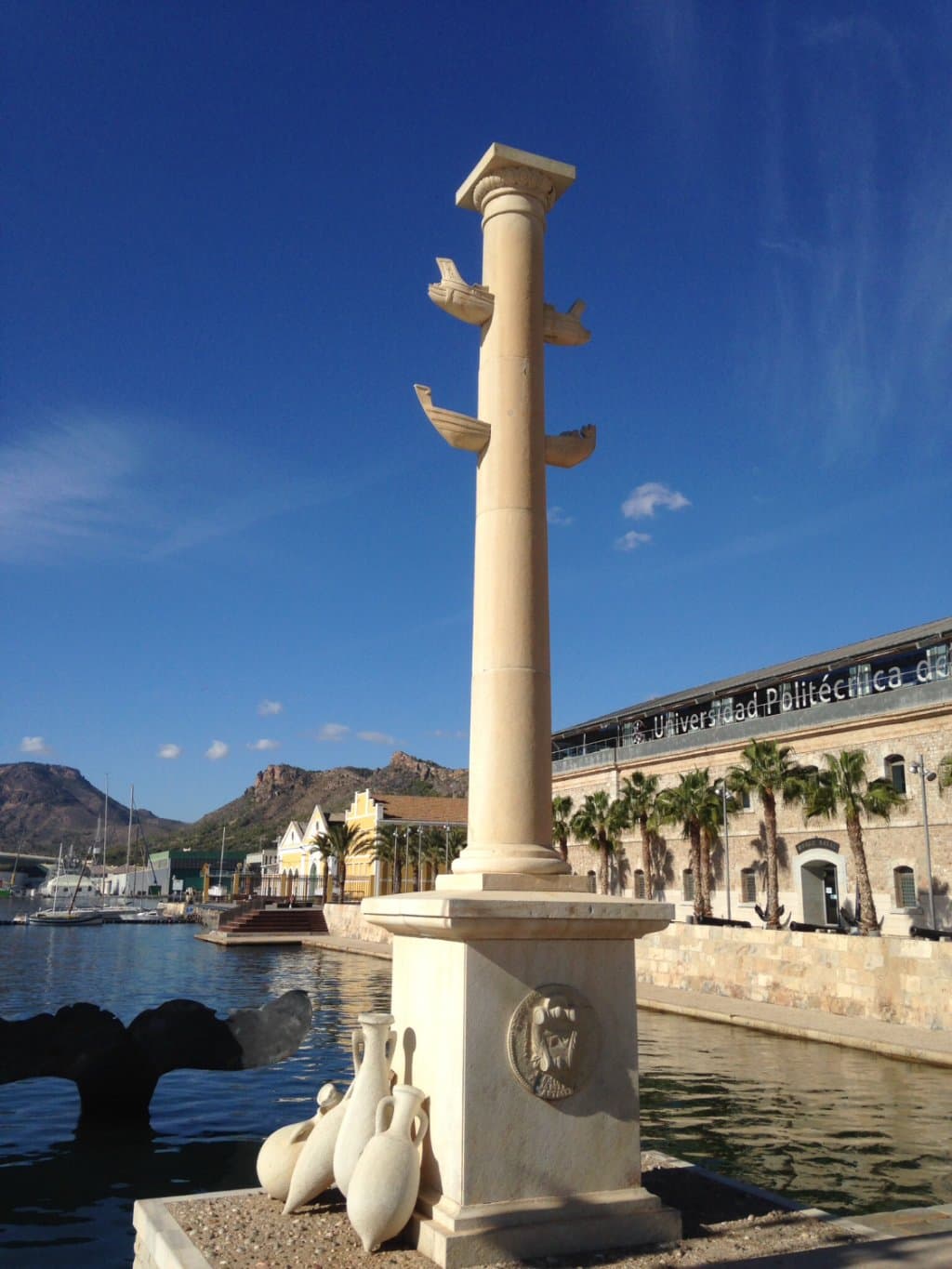 Romanesque statue with fin in background