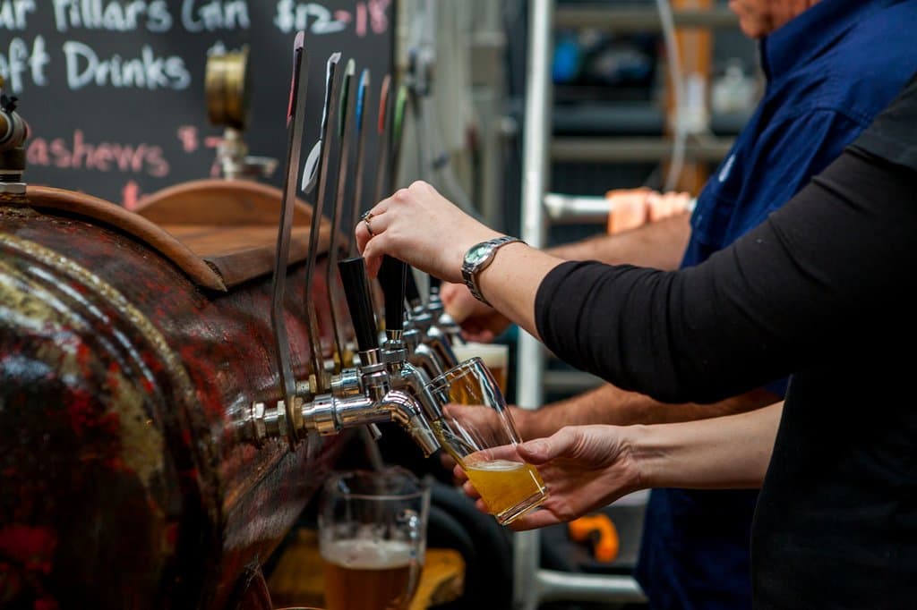 Pouring beers on the upcycled air compressor bar