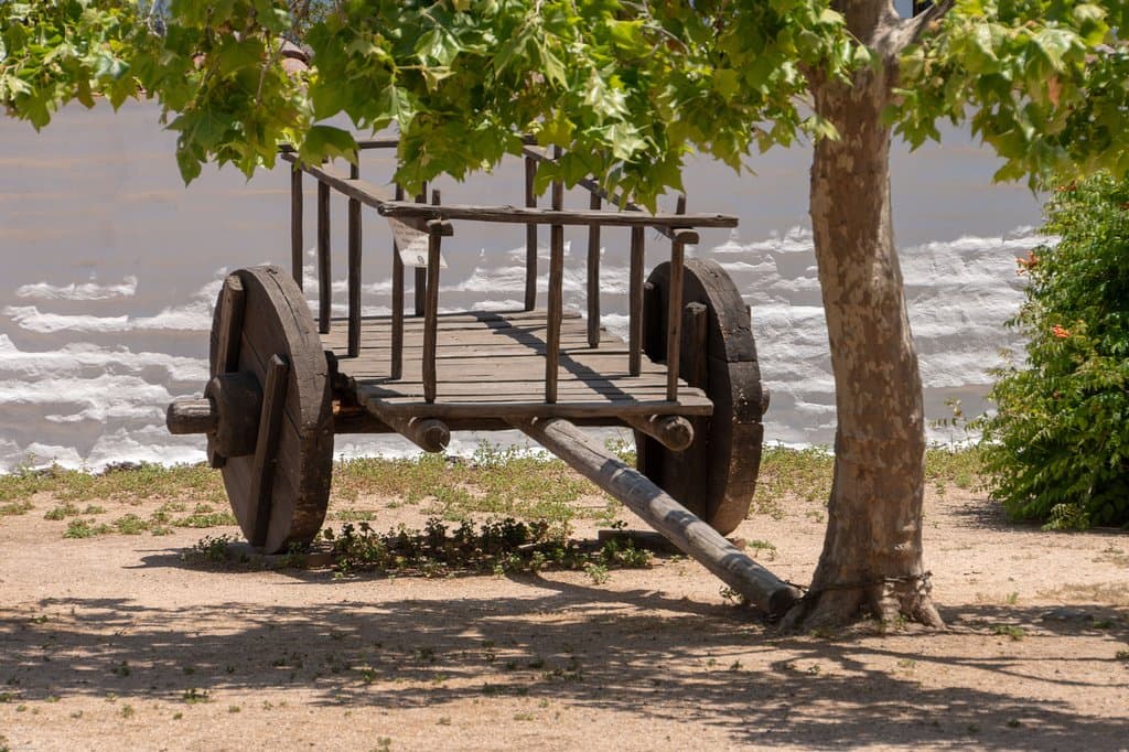 Old cart in front of adobe wall in the courtyard