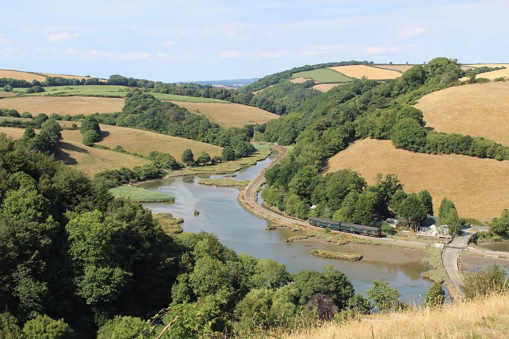 Looe Valley Line train makes its way along the estuary (just beyond Sandplace station).