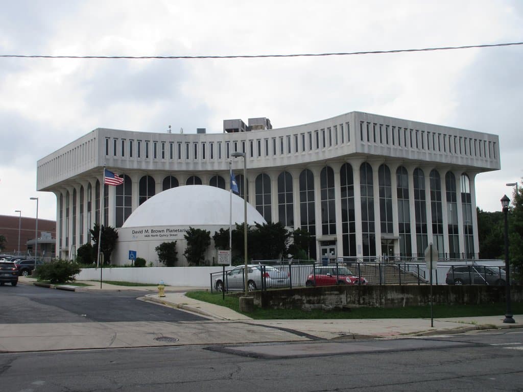 Is located in front of the Arlington public school admin building