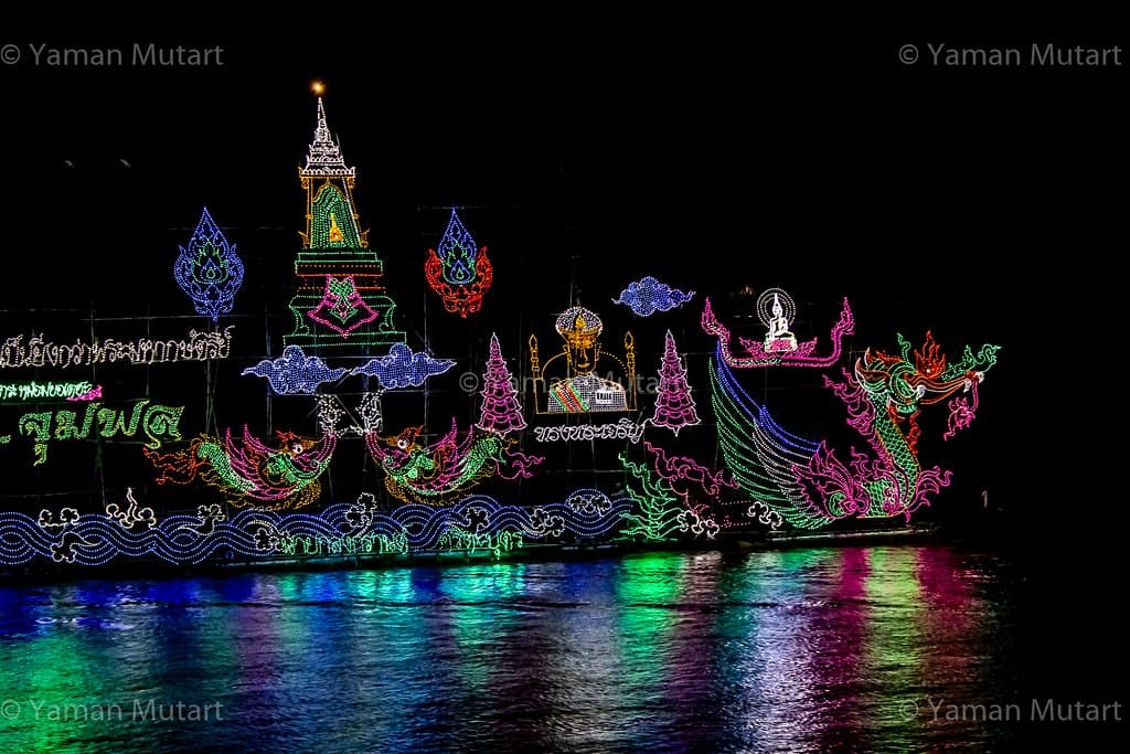 Brightly lit boats decorated with coloured lights