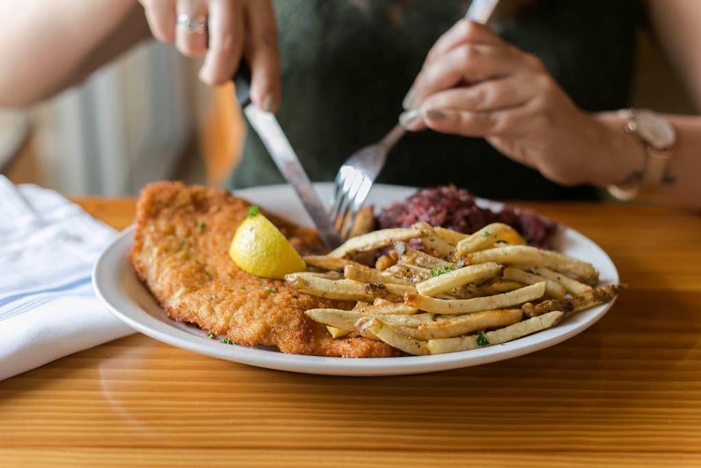 VIENNA SCHNITZEL - pork or chicken schnitzel, lemon wedge, french fries, red cabbage 