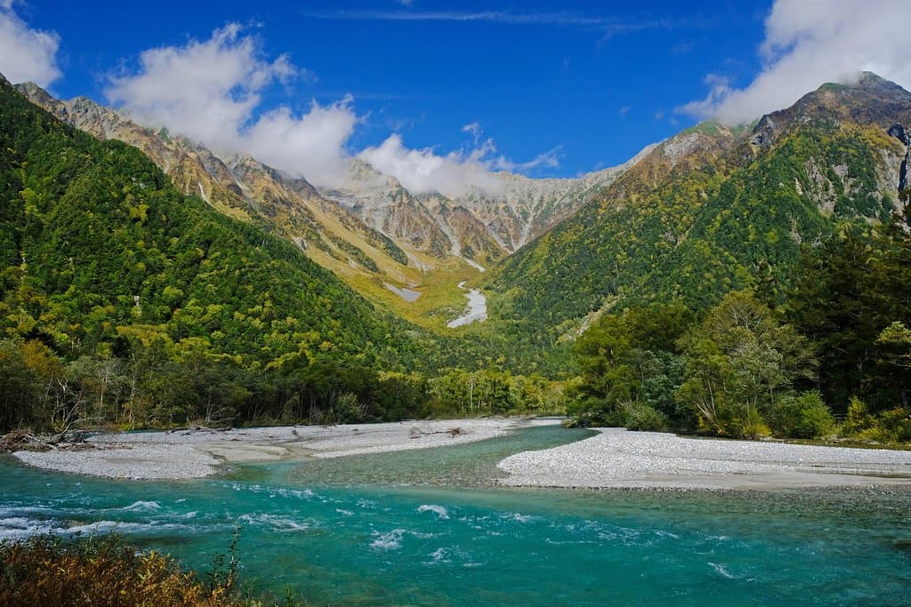 Beautiful mountain and turquoise river, on the verge of autumn colors