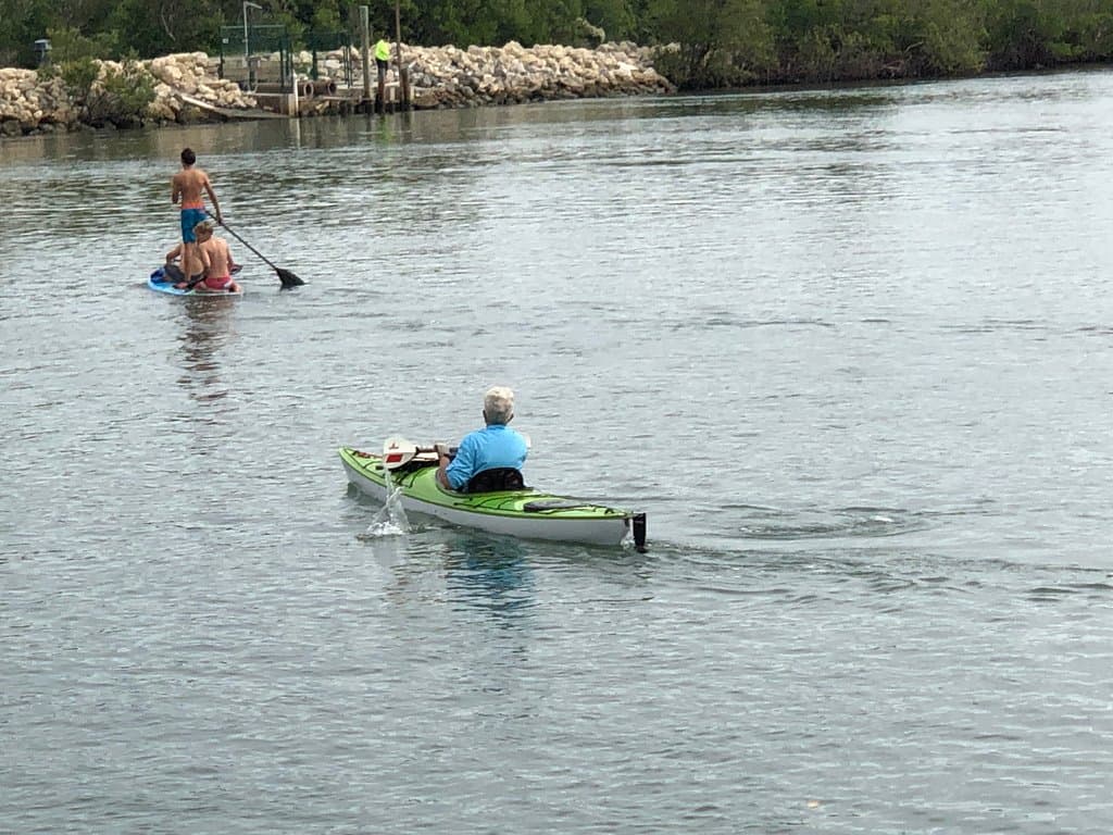 PADDLEBOARDING YOUTH AND KAYAKER