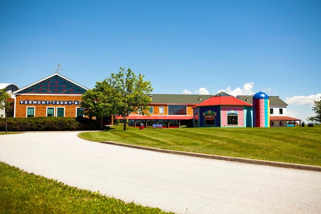 When you turn into our driveway, you are greeted by a wide open campus that stretches for acres. As you approach the front of our building, you are welcomed by maple trees, picnic tables, Adirondack chairs and our signature rainbow-colored silo and timber frame style-building.