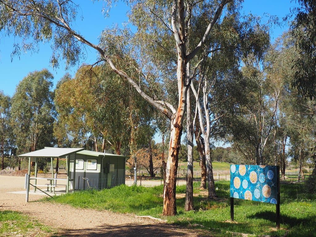 The entrance with parking and toilet. There is a fair bit of parking but it can be dusty. Also shows one of the 