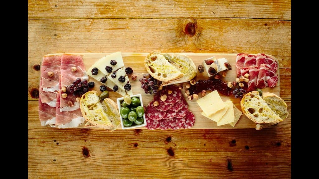assortment of Italian cured meats and cheeses