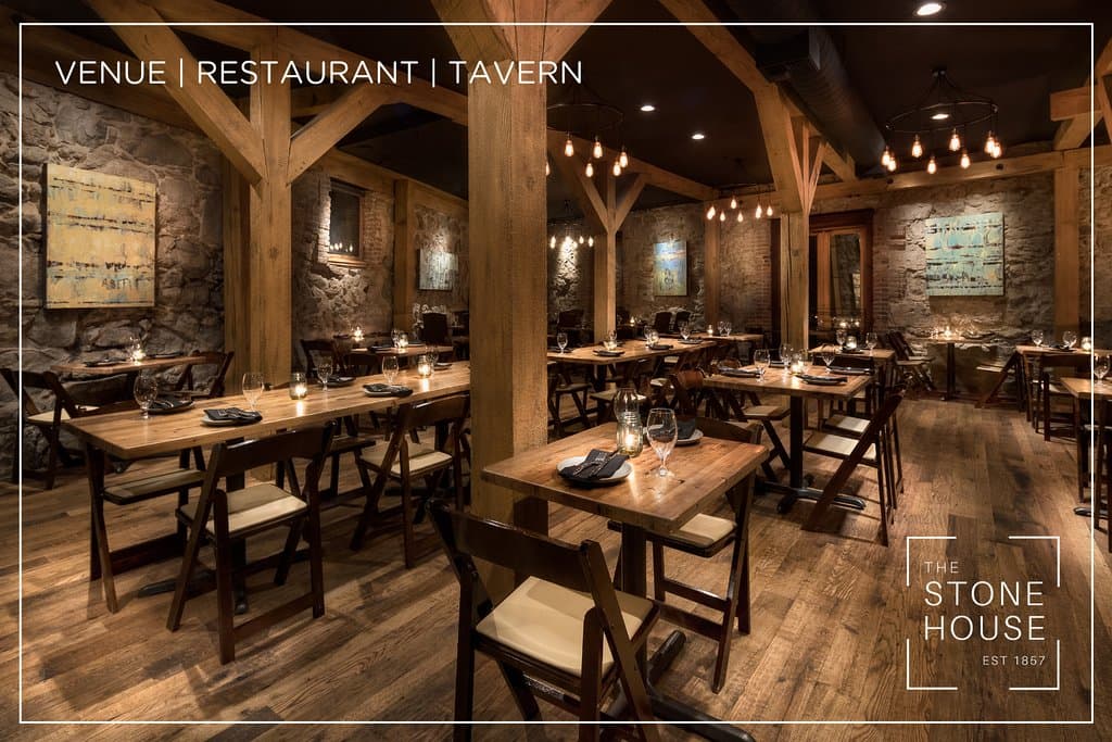 Stone walls, timber beams and elegant lighting set the backdrop in our rustic wooden dining room.