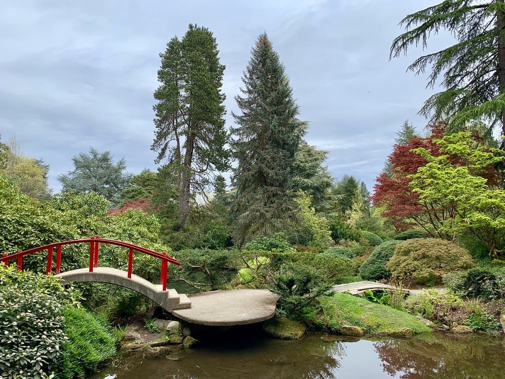 Traditional arched red footbridge.
