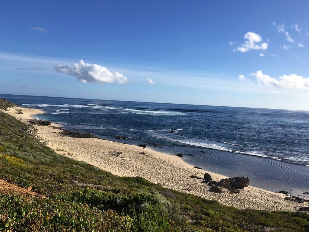 The coastline from headland above where you can find some grass and enjoy a picnic on the beach