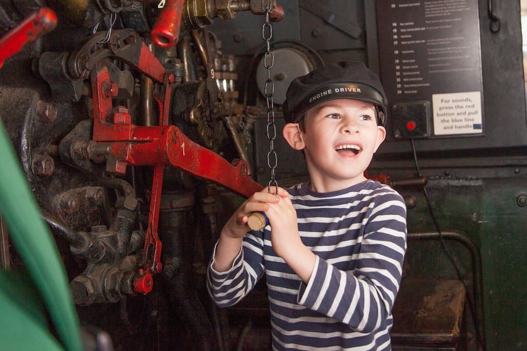 Boy pulling the whistle of the Tivvy Bumper steam engine