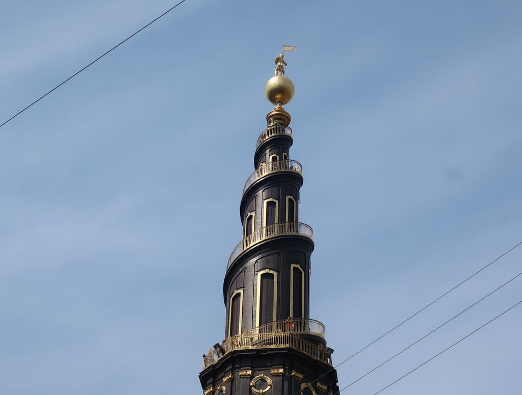 The spire goes up anti clockwise.