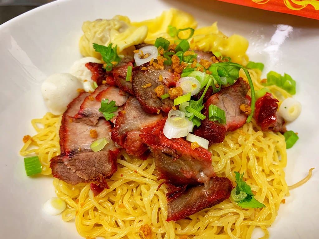 Bamee Moo Dang (dry style) egg noodle, serves with fish ball and BBQ red pork.