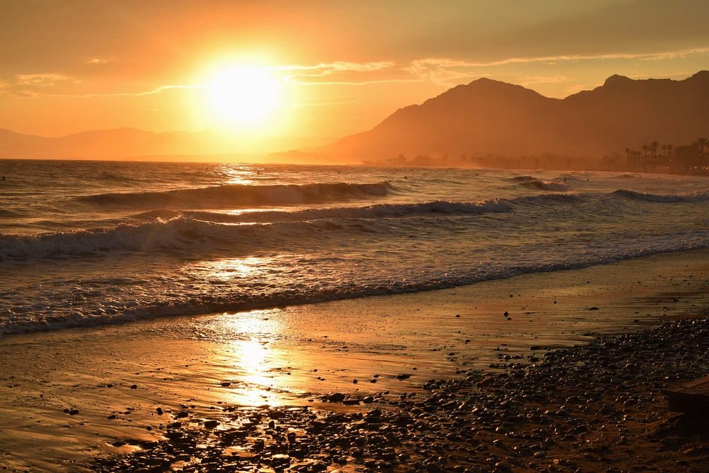 Sunset reflecting in the wet sand at Playa Castellar