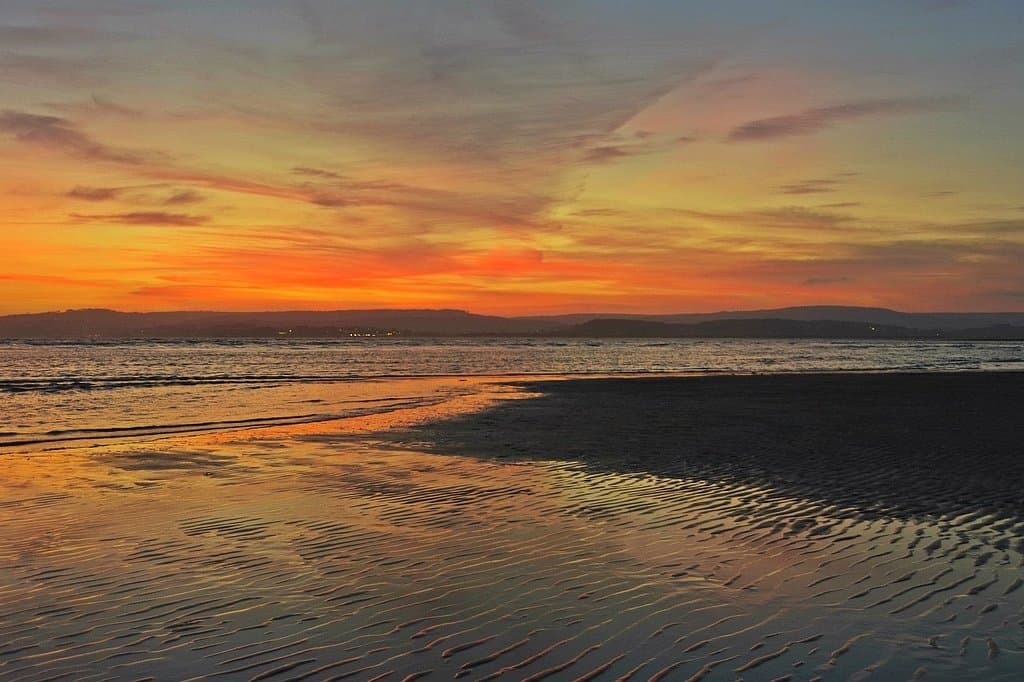 Exmouth seafront at Dusk taken from the area around Orcombe point .