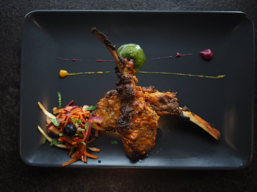 Tender grilled lamb chops marinated overnight in raw papaya and a blend of spices